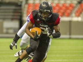 Terry Fox running back Jeremie Kankolongo shook off a separated shoulder and rushed for  four touchdowns Saturday as the Ravens advanced to the Subway Bowl semifinals.