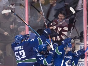 The Vancouver Canucks mob rookie defenceman Troy Stecher after he scored against the Dallas Stars with 1:40 left in the game to tie the score last week at Rogers Arena. Markus Granlund would go on to get the winner in a 5-4 overtime victory.