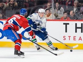 Bo Horvat #53 of the Vancouver Canucks looks to play the puck past Greg Pateryn #6 of the Montreal Canadiens during the NHL game at the Bell Centre on November 16, 2015 in Montreal, Quebec, Canada.