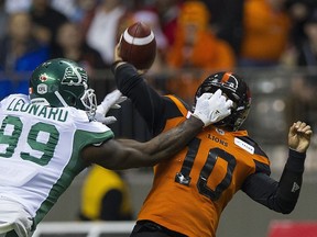 B.C. Lions QB Jonathan Jennings gets a mitt-full of pressure from Saskatchewan Roughriders during Saturday's game at B.C. Place.