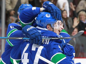 Sven Baertschi of the Canucks is congratulated after scoring the winning goal against the Wild.