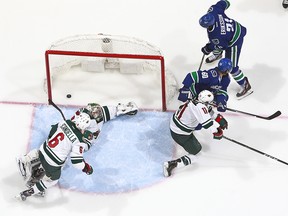 Loui Eriksson of the Canucks scores on Darcy Kuemper.