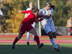 UBC Thunderbirds' Jasmin Dhanda, right, and Laval's Roxanne Dionne battle in the U Sports national final Sunday in Wolfville, N,S.
