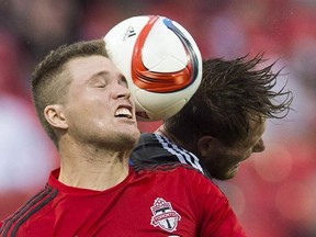 San Jose Earthquakes&#039; Adam Jahn, right, battles for the ball with Toronto FC&#039;s Eriq Zavaleta, left, during the second half MLS soccer action in Toronto, Saturday May 30, 2015. The MLS Cup is a reunion of sorts for Toronto FC defender Zavaleta. THE CANADIAN PRESS/Mark Blinch