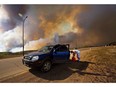 An evacuee puts gas in his car on his way out of Fort McMurray, Alta., on Wednesday May 4, 2016. The ferocious wildfire that forced nearly 90,000 to flee Canada's oilsands region and reduced thousands of homes to rubble has been picked as the top news story of 2016 in an annual survey of newsrooms across Canada by The Canadian Press. THE CANADIAN PRESS/Jason Franson ORG XMIT: CPT108