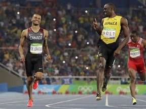 FILE - In this Aug. 17, 2016 file photo, Jamaica&#039;s Usain Bolt, right, and Canada&#039;s Andre De Grasse, compete in a men&#039;s 200-meter semifinal during the athletics competitions of the 2016 Summer Olympics at the Olympic stadium in Rio de Janeiro, Brazil. (AP Photo/David J. Phillip, File)