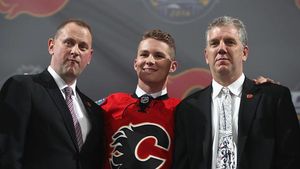 BUFFALO, NY - JUNE 24: Matthew Tkachuk poses onstage with Calgary Flames team personnel after being selected sixth overall by the Calgary Flames during round one of the 2016 NHL Draft at First Niagara Center on June 24, 2016 in Buffalo, New York. (Photo by Dave Sandford/NHLI via Getty Images)