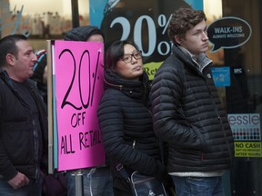 Shopers wait to enter a Boxing Day sale on Granville Street in 2015.