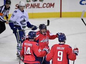Capitals right wing Justin Williams (14) celebrates his goal with Alex Ovechkin and defenseman Dmitry Orlov.