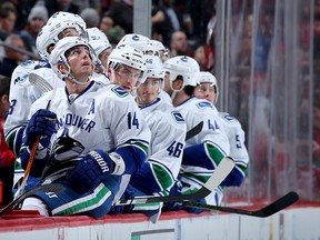 Alex Burrows and the rest of the Canucks watch the replay of Henrik Sedin's goal in the third period.