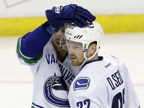 Vancouver Canucks left wing Daniel Sedin (22) is congratulated by teammate Brandon Sutter after Sedin scored against the Florida Panthers in the third period of an NHL hockey game, Saturday, Dec. 10, 2016, in Sunrise, Fla. The Panthers won 4-2.