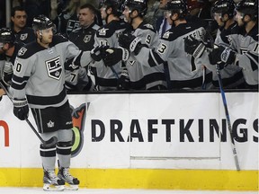 Los Angeles Kings right wing Devin Setoguchi, left, celebrates with teammates after scoring against the Calgary Flames during the first period of an NHL hockey game in Los Angeles, Saturday, Nov. 5, 2016.