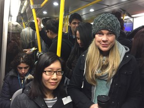 Melody Lau and Christine Swanson aboard a packed Evergreen Line train Monday morning. They are both trying out the new SkyTrain extension to see if it cuts down their commute. But Monday's unexpected snowfall snarled traffic. Photo: Jeff Lee