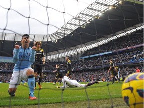 Manchester City's Argentinian striker Sergio Aguero (L) celebrates after Ivorian midfielder Yaya Toure (not pictured) scores the opening goal of the English Premier League football match between Manchester City and Chelsea at the Etihad Stadium in Manchester in 2013.