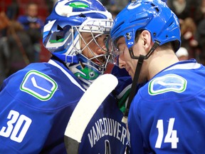 Ryan Miller is congratulated by Alex Burrows after the Canucks' 2-1 win over the Kings.