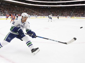 Vancouver Canucks' Henrik Sedin (33) reaches for the loose puck against the Edmonton Oilers during first period NHL action in Edmonton, Alta., on Saturday December 31, 2016.