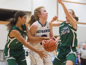 Seycove Seyhawks centre/forward Ashley Bradshaw tries to split the Riverside Rapids defence of Sammy Shields, left, and Adrienne Willems on Thursday. Bradshaw led all players with 30 points and the Seyhawks won 83-70.