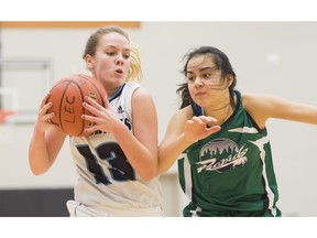 Seycove Seyhawks point guard Kayla Krug, left, drives past Keimi Cuellar of the Riverside Rapids during the opening game of the Tsumura Basketball Invitational at the Langley Events Centre in December. Krug is hoping for more success at the LEC this week when the Double A provincials are contested.