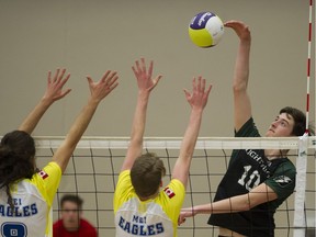 Langley Christian Lightning's Brodie Hofer (right) spikes home a point past Abbotsford's MEI Eagles in semifinal action at the B.C. double-A boys volleyball championships Friday at the Langley Events Centre. Hofer was the tournament’s most outstanding player.
