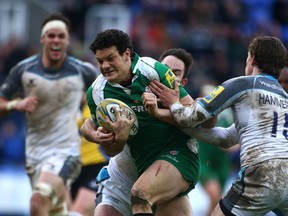 READING, ENGLAND - JANUARY 10: Ciaran Hearn of London Irish breaks through the Newcastle Falcons' defence during the Aviva Premiership match between London Irish and Newcastle Falcons at The Madejski Stadium on January 10, 2016 in Reading, England.