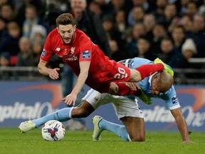 Manchester City's Vincent Kompany, right, and Liverpool's Adam Lallana will renew acquaintances when the two teams meet on New Years' Eve day.