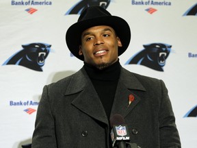 Carolina Panthers quarterback Cam Newton wears a black coat and hat as he talks with reporters during a post-game news conference after an NFL football game against the Seattle Seahawks, Sunday, Dec. 4, 2016, in Seattle. The Seahawks won 40-7.