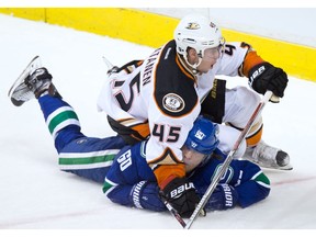 Anaheim Ducks' Sami Vatanen, top, of Finland, falls on Vancouver Canucks' Markus Granlund, of Finland, after taking him down on a breakaway during the second period of an NHL hockey game in Vancouver, B.C., on Thursday December 1, 2016.