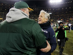 Seattle Seahawks head coach Pete Carroll, right, congratulates Mike McCarthy, his counterpart with Green Bay, after the Packers obliterated the Hawks 38-10 on Sunday, Seattle's worst loss in five years.