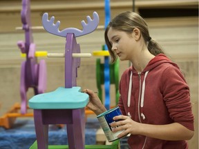 Volunteers put the finishing touches on rocker toys at Fraser Heights Secondary school's woodworking shop. The toys will be distributed through the Surrey Christmas Bureau, which is one of the agencies supported by The Province's Empty Stocking Fund.