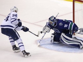 Toronto Maple Leafs' Austin Matthews (34) is stopped by Vancouver Canucks goaltender Ryan Miller (30) during shootout NHL hockey action, in Vancouver on Saturday, December 3, 2016.