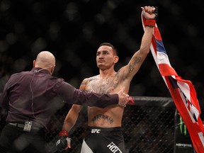 Max Holloway celebrates his victory over Jeremy Stephens in a featherweight fight during UFC 194 on December 12, 2015 in Las Vegas, Nevada. (Steve Marcus/Getty Images)