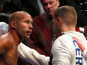LAS VEGAS, NV - AUGUST 20:  Donald Cerrone (L) listens to a member of his team between rounds during his welterweight bout against Rick Story at the UFC 202 event at T-Mobile Arena on August 20, 2016 in Las Vegas, Nevada.  (Photo by Steve Marcus/Getty Images)