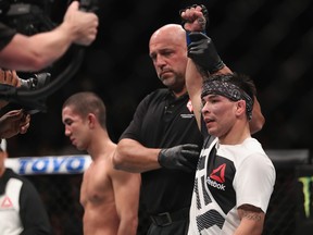 LAS VEGAS, NV - DECEMBER 30: Ray Borg (right) reacts to his victory over Louis Smolka (left) in their flyweight bout during the UFC 207 event on December 30, 2016 in Las Vegas, Nevada.  (Photo by Christian Petersen/Getty Images)