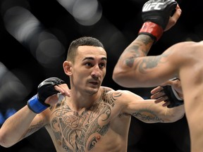 US' Max Holloway (L) and Sweden's Akira Corassani (R) fight in the ring during the Ultimate Fighting Championship (UFC) Fight Night at the Globe Arena in Stockholm on October 4, 2014. AFP PHOTO/JONATHAN NACKSTRAND        (Photo credit should read JONATHAN NACKSTRAND/AFP/Getty Images)