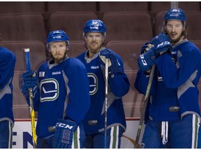 Alex Biega, Daniel Sedin and Andrey Pedan in practice ahead of the Kings game on Wednesday.
