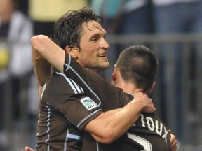 Whitecaps John Thorrington, left, hugs goal-scorer Sebastien Le Toux in their 1-0 win over the Colorado Rapids in MLS action at B.C. Place Stadium at Vancouver in June 2012. About a year ago, Thorrington was hired as executive vice-president of soccer operations for Los Angeles FC, who join MLS in 2018. Arlen Redekop/ PNG files