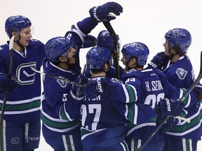 Vancouver Canucks' Henrik Sedin (33) celebrates his game-winning goal against the Anaheim Ducks with teammates Troy Stecher (51), Luca Sbisa (5), Ben Hutton (27) and Loui Eriksson (21) during overtime NHL hockey action in Vancouver on Friday, December 30, 2016.