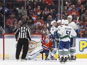 Vancouver Canucks players celebrate a goal against the Edmonton Oilers during second period NHL action in Edmonton, Alta., on Saturday December 31, 2016.