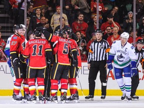 Mikael Backlund #11 of the Calgary Flames celebrates after scoring his team's third goal against the Vancouver Canucks during an NHL game at Scotiabank Saddledome on December 23, 2016 in Calgary, Alberta, Canada.