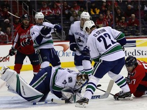 Canucks goalie Jacob Markstrom smothers the puck during Vancouver's 3-0 loss against the Washington Capitals Sunday.