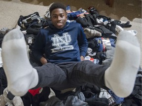 Notre Dame Jugglers quarterback/point guard Will Clarke collects socks for the needy.