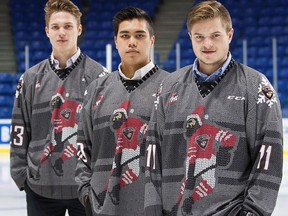 Taden Rattie, Ryan Jones and Johnny Wesley (left to right) show off the Ugly Christmas Sweater jerseys that the Vancouver Giants will wear this weekend.
