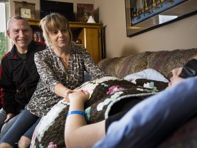 Chris and Hollie Hall comfort their 15-year-old daughter, Lily, who is undergoing treatment for inoperable brain cancer.