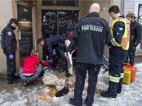 Firefighters tend to an unresponsive man who injected a drug in Vancouver's Downtown Eastside on Dec. 9.