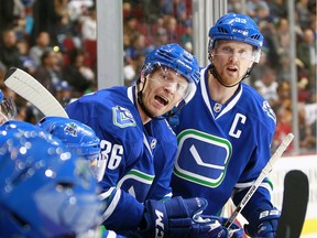 Jannik Hansen and Henrik Sedin of the Vancouver Canucks sit on the bench during Tuesday's game against the Winnipeg Jets  at Rogers Arena. Hansen is one of the few players who has found success playing on the Sedins' line, but his skills and speed make him one of the few marketable players other teams might be interested in.