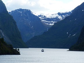 Sognefjord is the longest and deepest fjord in Norway, with mountain peaks on either side.
