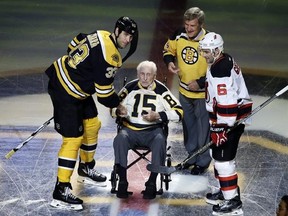 FILE - In this Oct. 20, 2016, file photo, Boston Bruins defenseman Zdeno Chara (33) and New Jersey Devils defenseman Andy Greene (6) participate with Bruins legends Milt Schmidt (15) and Bobby Orr in a ceremonial puck drop before an NHL hockey game in Boston. Schmidt, a hockey hall of famer, has died at the age of 98, Bruins team spokesman Matt Chmura said Wednesday, Jan. 4, 2017. Schmidt, the NHL MVP in 1951, was the league&#039;s oldest living former player. (AP Photo/Elise Amendola, File)