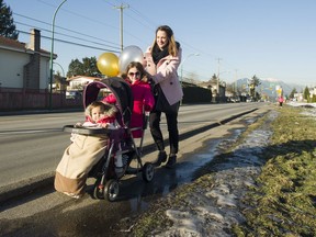 Cheryl McManus, 33, pushers her daughters, Paisley, 1, and Sydney, 4, along Willingdon Avenue parallel to the proposed Willingdon greenway project in Burnaby on Jan. 12. Gerry Kahrmann/PNG files