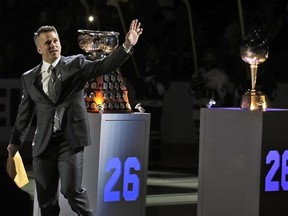 Former Tampa Bay Lightning right winger Martin St. Louis waves as he walks by some of his awards during a jersey retirement ceremony before an NHL hockey game between the Lightning and the Columbus Blue Jackets on Friday, Jan. 13, 2017, in Tampa, Fla. (AP Photo/Chris O&#039;Meara)