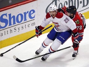 Montreal Canadiens defenceman Jeff Petry, left, controls the puck against Chicago Blackhawks left wing Artemi Panarin during the first period of an NHL hockey game in Chicago, Sunday, Nov. 13, 2016. A little past the half way point of the NHL season, Petry has already reached his career high with eight goals and is only three points shy of his best points total. THE CANADIAN PRESS/AP/Nam Y. Huh